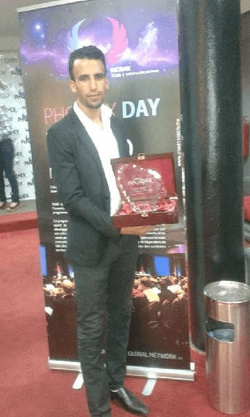 Ismail Essabar holding an award at Phoenix Day