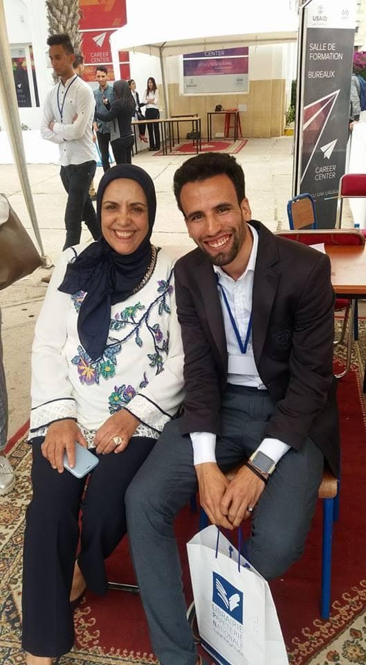 Ismail Essabar seated with a guest at the USAID Career Center