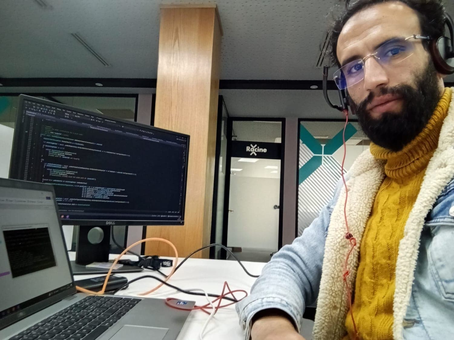 Ismail Essabar at a desk with code on the monitor