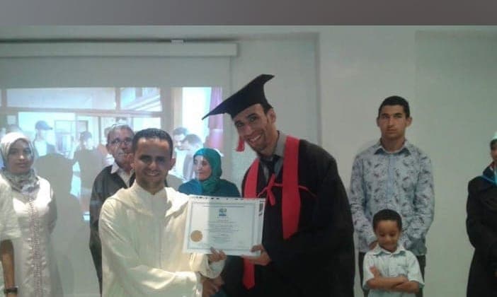 Ismail Essabar receiving a diploma in cap and gown