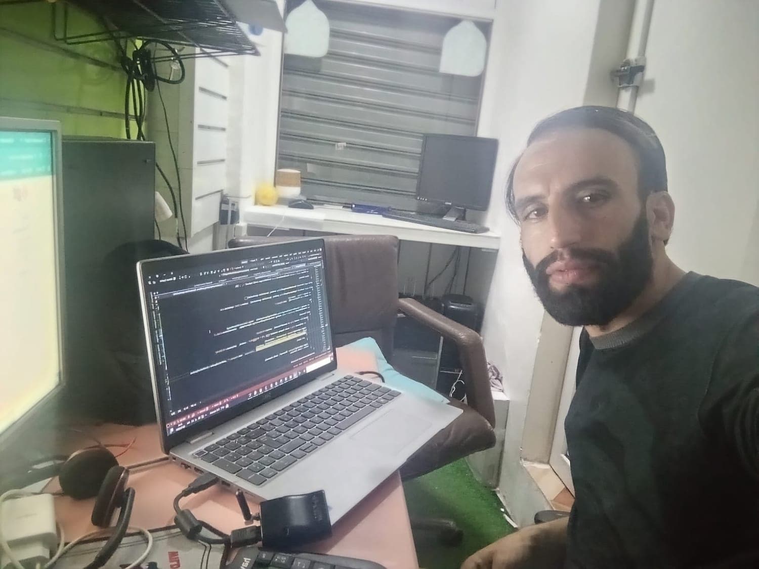 Ismail Essabar working on a laptop away from the office