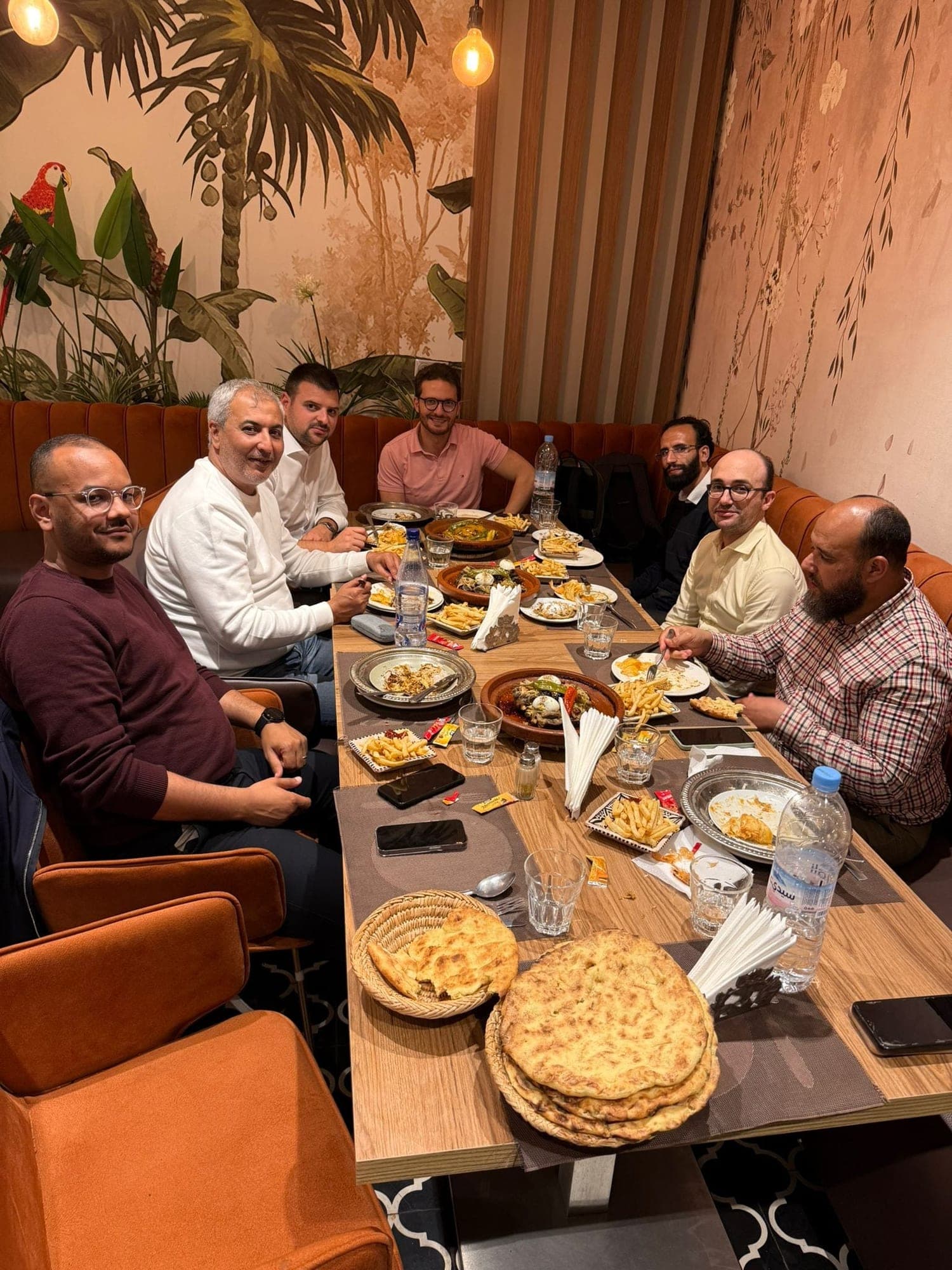 Ismail Essabar at dinner with colleagues around a long table