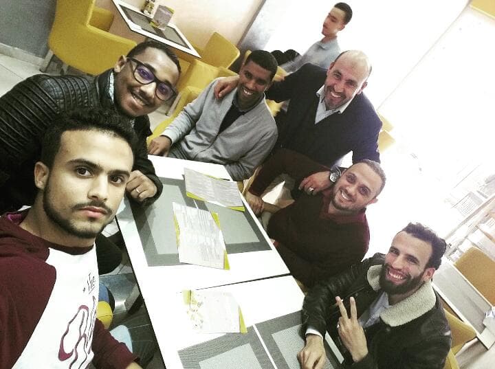 Ismail Essabar in a working session around a table with colleagues